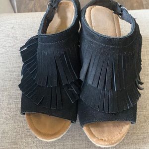 Black fringed Minnetonka wedge sandal